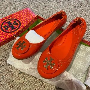 Tory Burch flats for sale in the color orange. Size 7.